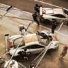 Dos McLaren MP4 GT3 librea Gulf en movimiento en pit lane durante repostaje – fotografía artística edición 14 ejemplares
