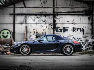 Lienzo Porsche coche de carreras fotografiado en almacén industrial antiguo, ambiente moody industrial con iluminación dramática, arte de pared automovilístico de competición edición limitada Cars and Roses