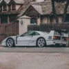 Ferrari F40 gris de perfil frente a arquitectura rural europea – fotografía artística supercoche edición limitada 200 ejemplares