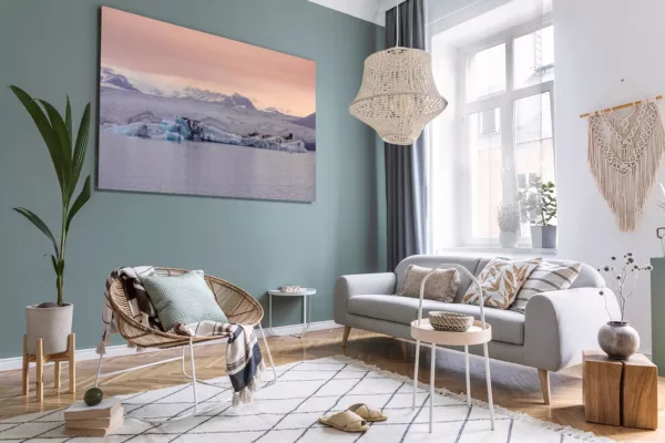 e5ea4db823558fd1ee8fa8ca2b65cd6bd5c15911aa74151a782ff81c2ce48b62 Cuadros fotografía glaciar Jökulsárlón icebergs azules exhibidos en salón escandinavo moderno con sofá gris pared blanca y decoración minimalista nórdica contemporánea