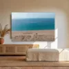 Cuadro playa Zahara de los Atunes mockup Cuadro fotografía de la playa de Zahara de los Atunes sobre un aparador de rattán en un luminoso salón andaluz